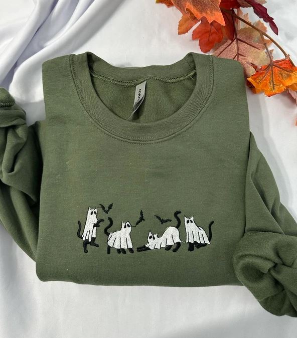 ử A spooky black cat embroidered across the chest feels playful yet refined.